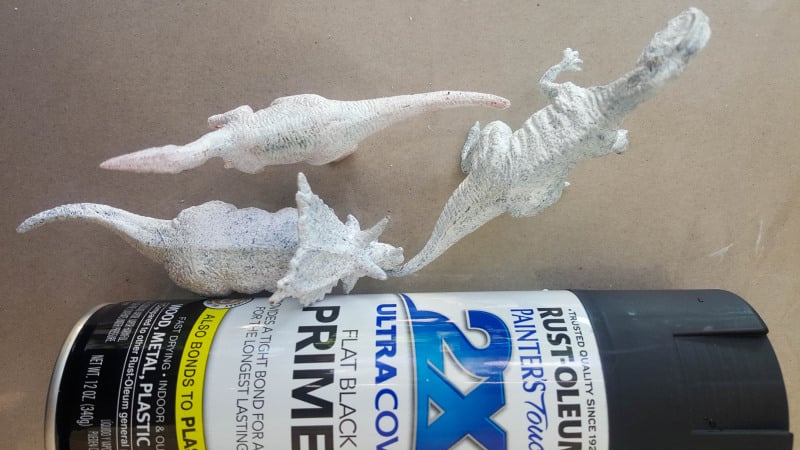Paint the dinosaurs a flat black