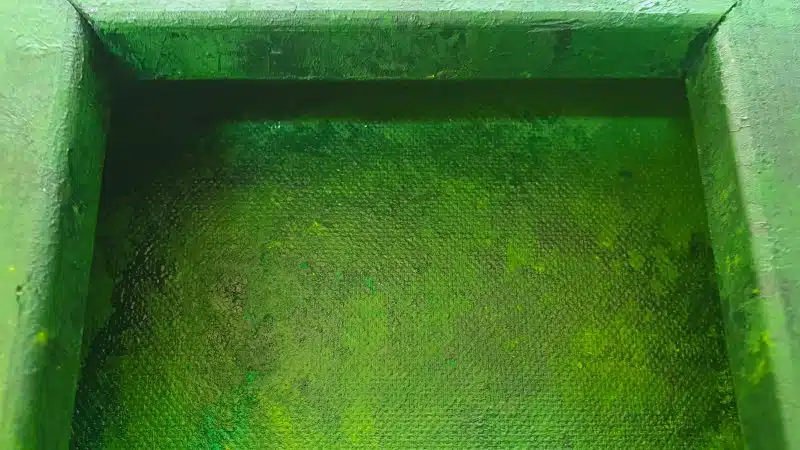 Paint the canvas and wooden frame green
