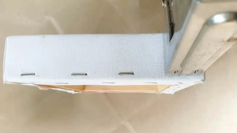 Put new staples along the outside edge of the box canvas