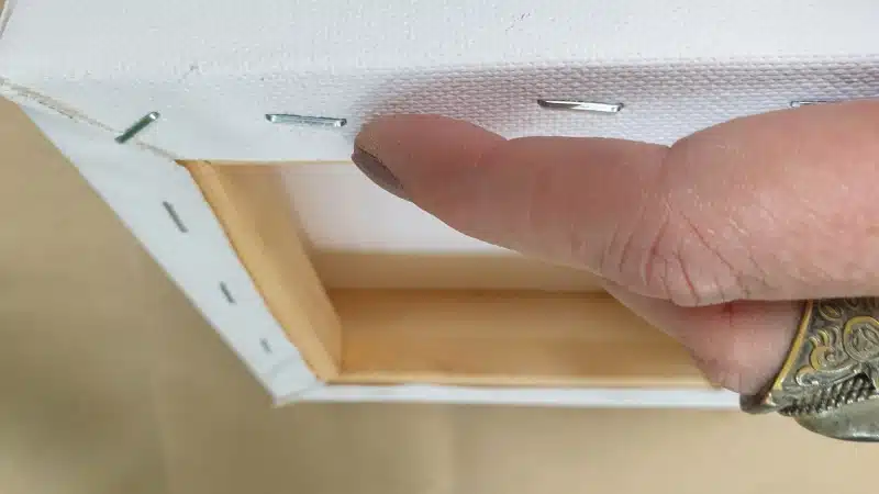 Remove the staples from the canvas