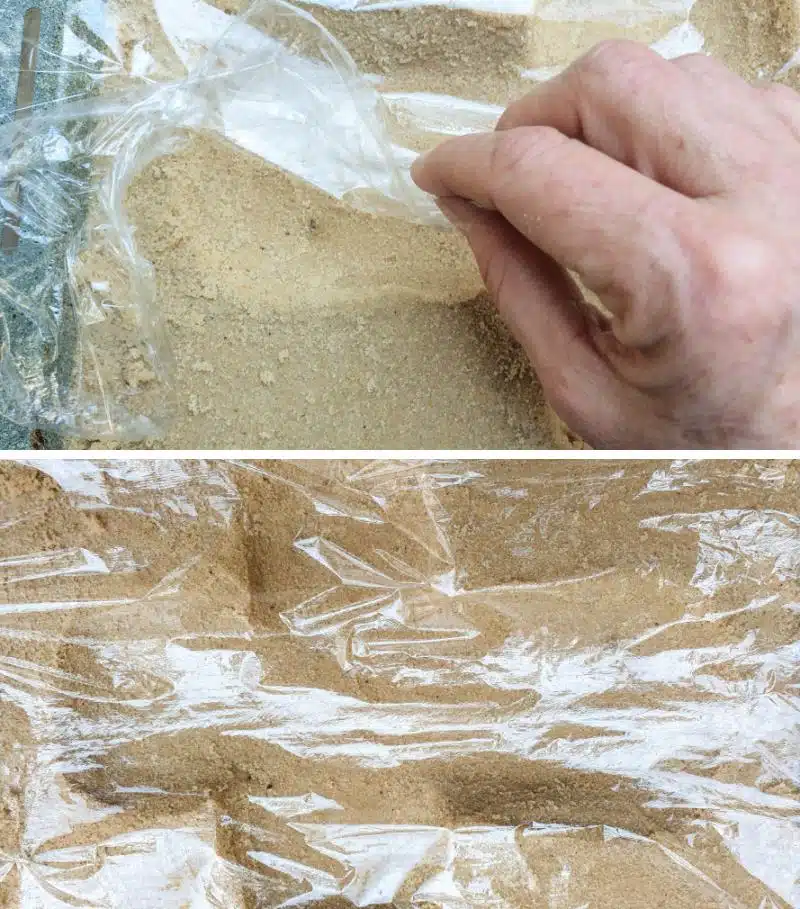 Cover the wet sand with cling film (Saran Wrap)