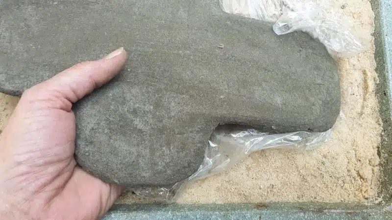 When the concrete is dry to the touch remove it from the sand mold