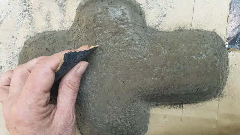 Use 80-grit sandpaper to smooth out the cross