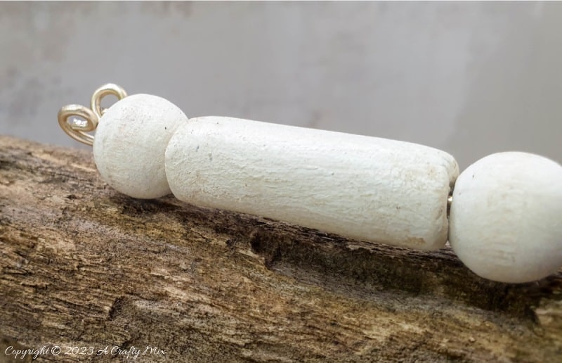 This easy tutorial will who you how to create a large wooden bead dragonfly that is sure to be a conversation starter in any room. You can experiment with different colors, shapes, and sizes to create a one-of-a-kind dragonfly that reflects your personal style and creativity. #ACraftyMix