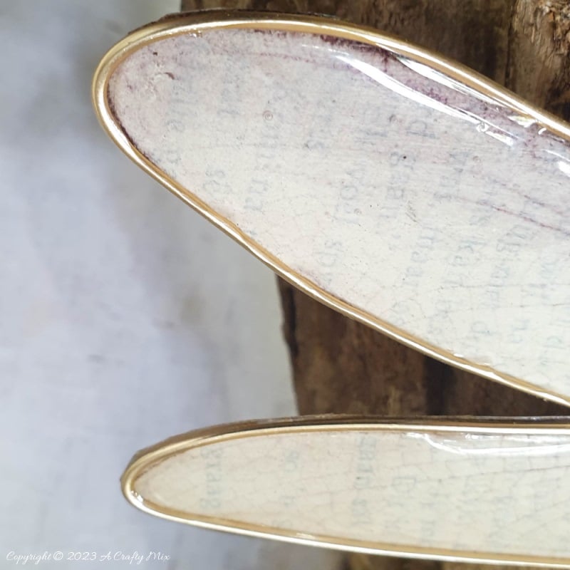 This easy tutorial will who you how to create a large wooden bead dragonfly that is sure to be a conversation starter in any room. You can experiment with different colors, shapes, and sizes to create a one-of-a-kind dragonfly that reflects your personal style and creativity. #ACraftyMix