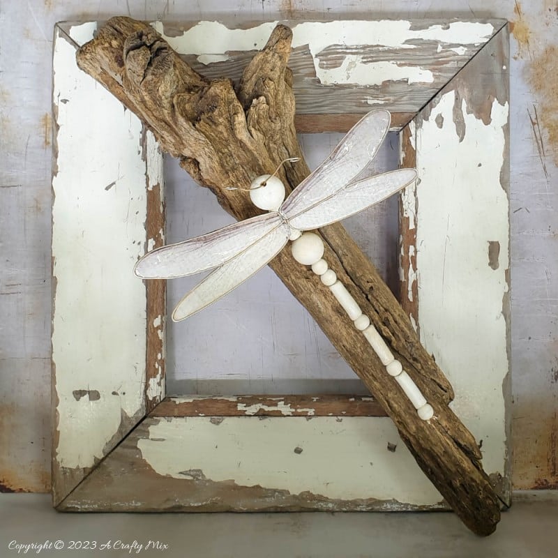 This easy tutorial will who you how to create a large wooden bead dragonfly that is sure to be a conversation starter in any room. You can experiment with different colors, shapes, and sizes to create a one-of-a-kind dragonfly that reflects your personal style and creativity. #ACraftyMix
