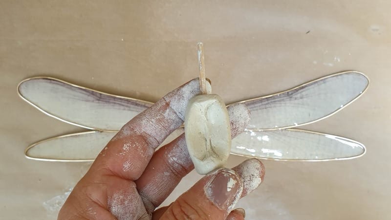 Press the wings down firmly into the wing support bead
