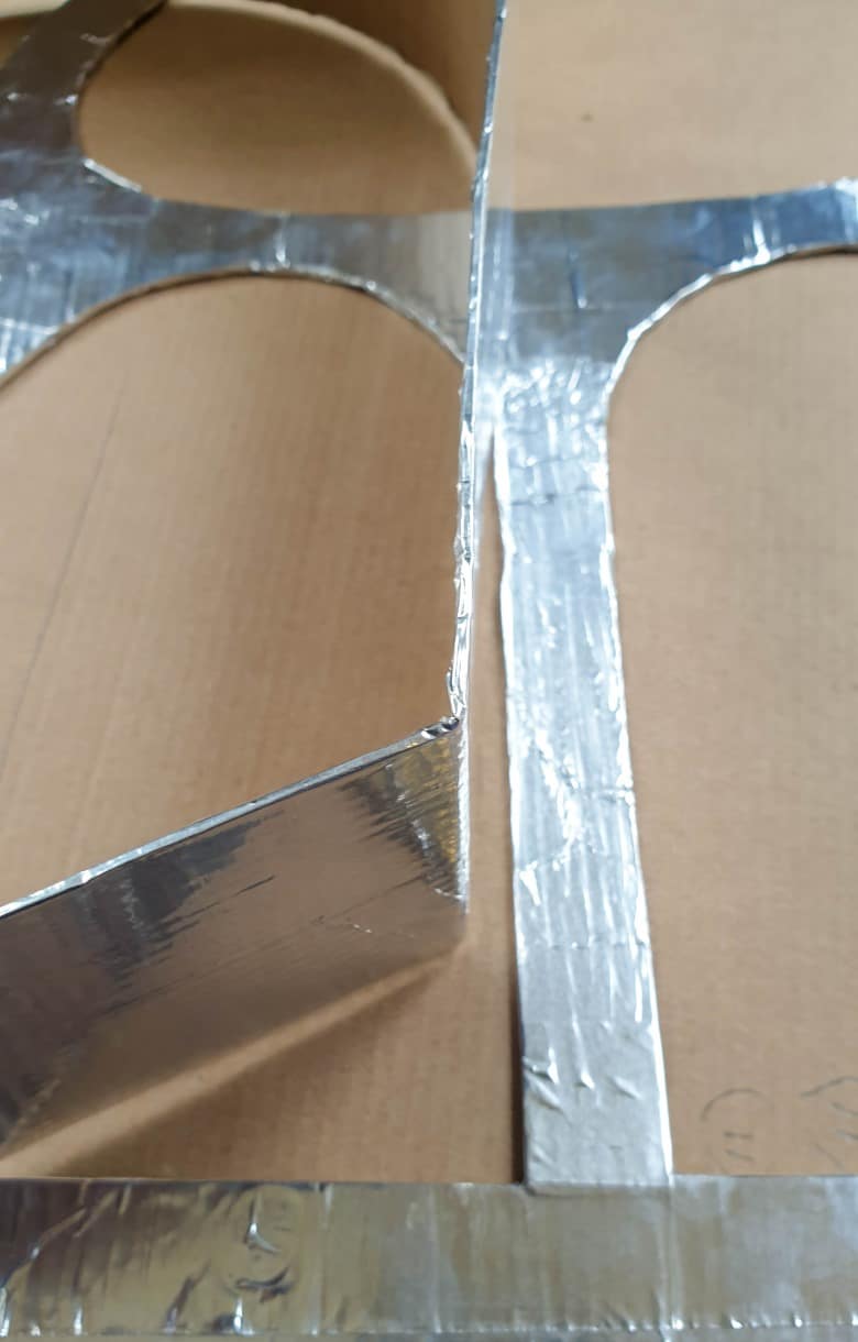 Wrap all the cardboard pieces that will be exposed to the concrete in aluminium tape