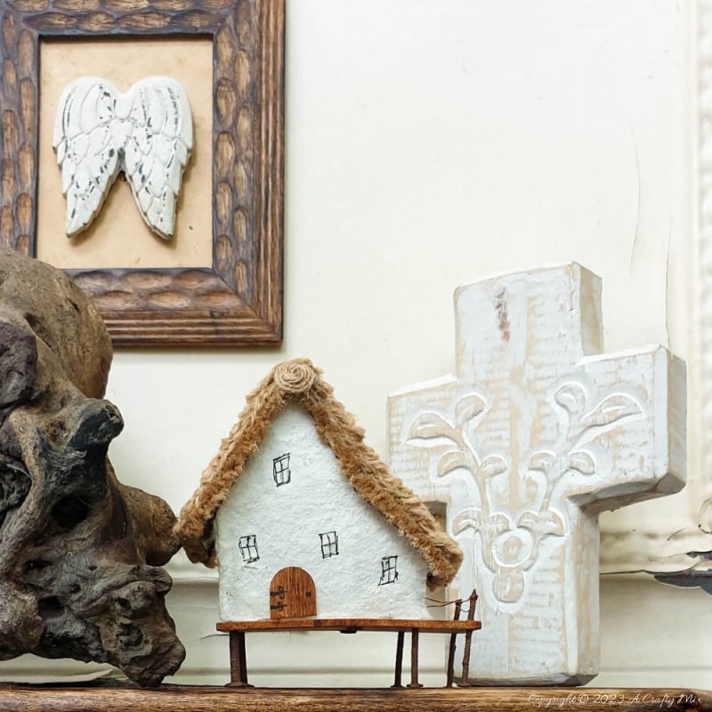 This paper house with a miniature thatch roof is made entirely from scraps and recycled materials, giving it a creative, whimsical feel. The lights add a little magic, and we all need more of that in our lives. In this step-by-step tutorial, we&rsquo;ll show you how you can make your own and share an easy way to thatch a small roof. #ACraftyMix