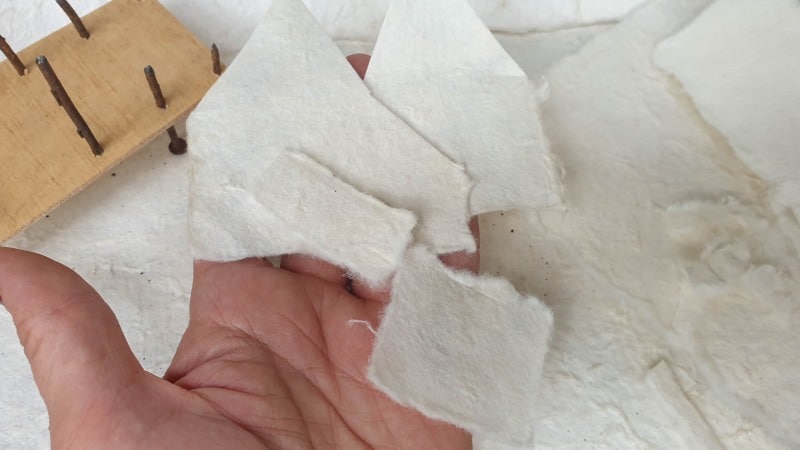 Tear the scrap paper to form walls for the house