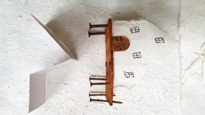 Glue the paper walls to the rusty nail supports
