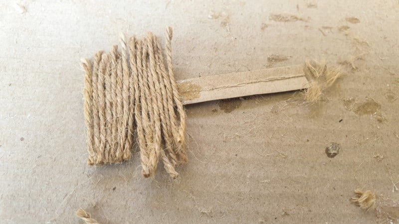 Glue the cut twine onto a strip of cardboard