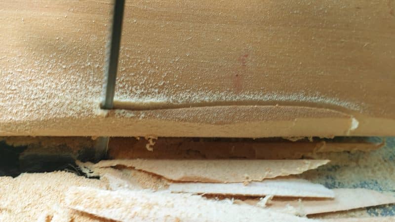 Make random cuts all along the edge of the scrap wood