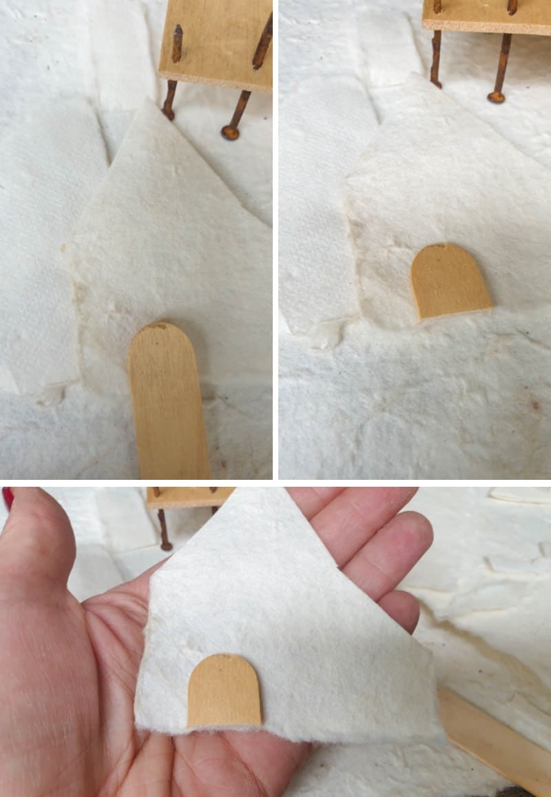 Cut a tongue depressor to make a tiny door for the paper house