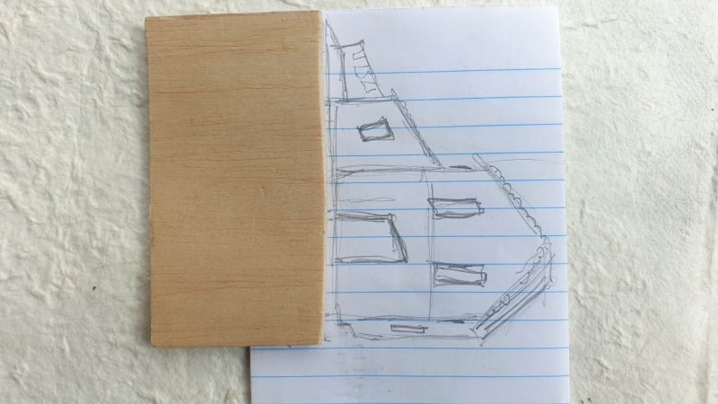 Cut a base for the paper house using cardboard or balsa wood