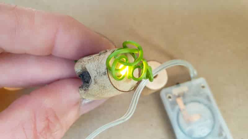 Thread the fairy lights through the hole in the stump