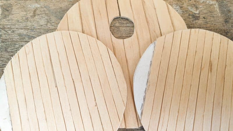 Cut the wooden craft sticks to fit on the cardboard templates