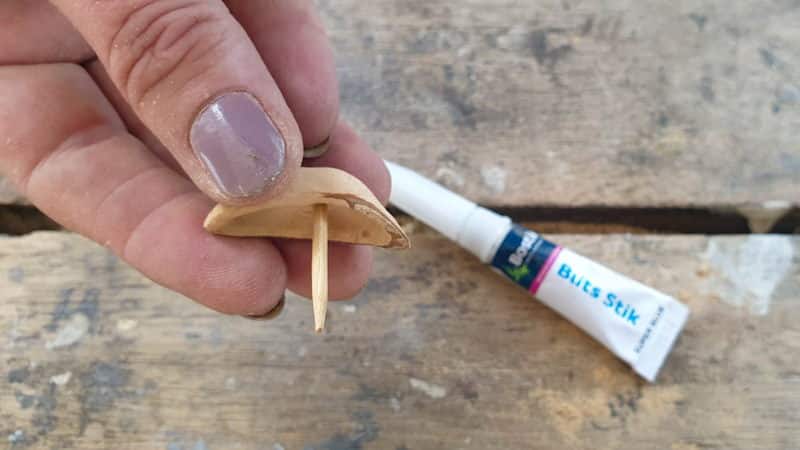 Glue on a toothpick on for a mast