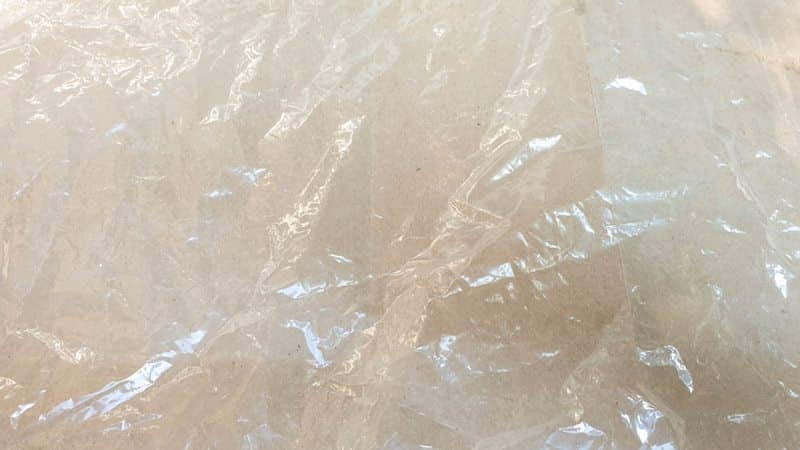Prep your work area by laying down a piece of cardboard covered in plastic