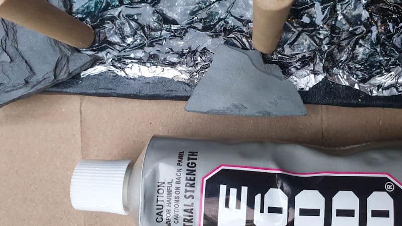 Glue the slate chips or shards all around the cardboard tray