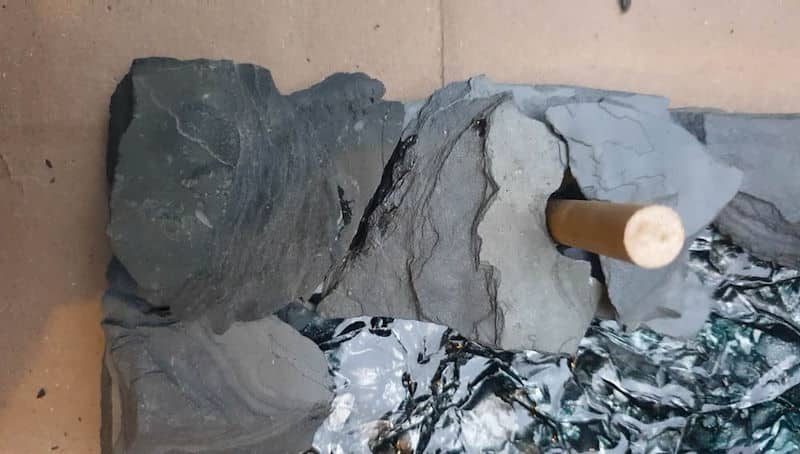 Glue the slate chips or shards all around the cardboard tray