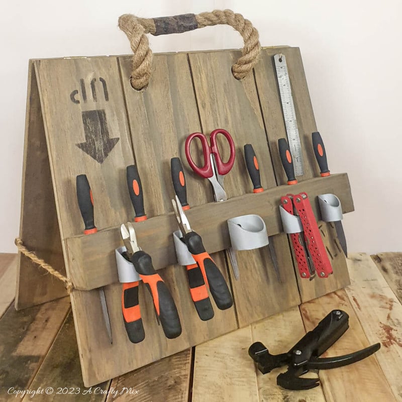 Tired of looking for your tools? Conquer the chaos with this easy DIY toolbox caddy! Crafted from scrap wood, this budget-friendly solution will keep your tools neatly arranged and within easy reach. Spend a morning on this fun project and transform your workspace into an organized haven. The best part? You can customize the compartments and design to fit your tools perfectly. #ACraftyMix