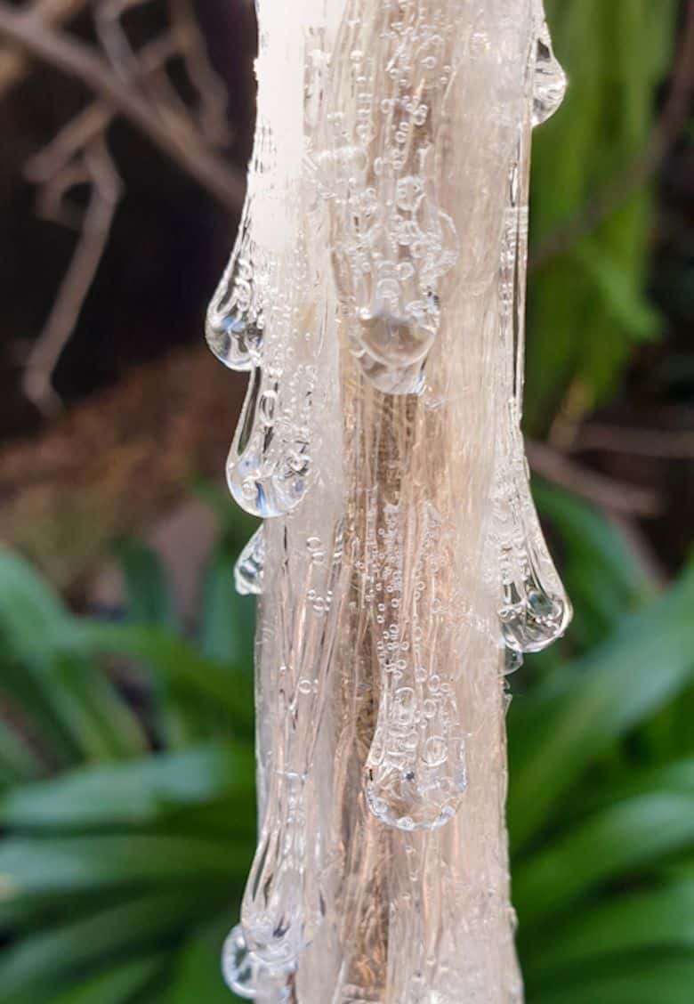 Add drops of clear glue over the cling wrap