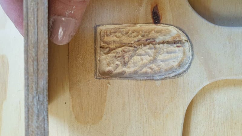 A view of the carved away battery area showing the layers of pressed wood