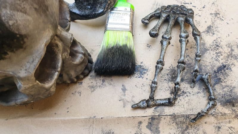 Paint the skull and skeleton hands black