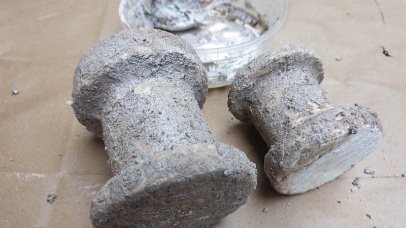 Two upcycled candleholders covered with wet texture paste