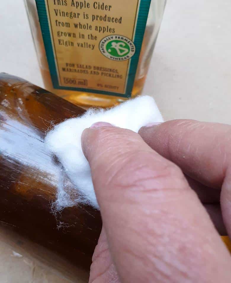 Wash and clean the bottle and wipe it down with vinegar to get rid of any oily residue