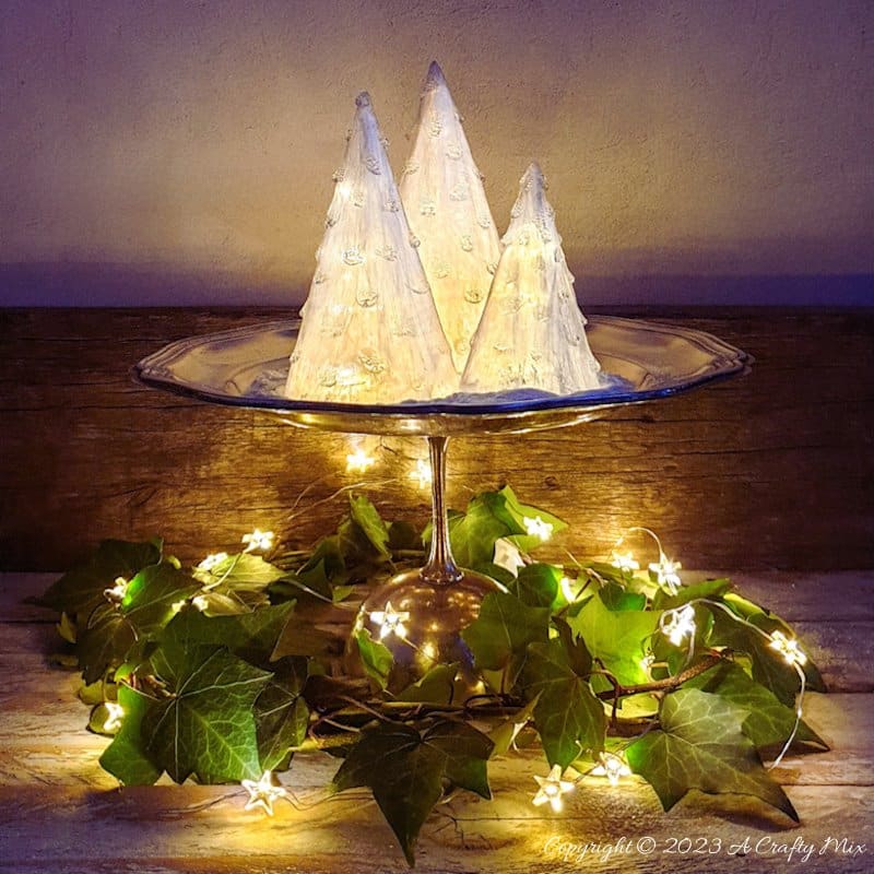 These upcycled shimmering light-filled Christmas trees are inexpensive and easy-to-make. The perfect holiday decorations to dress up your windowsill, tabletop, or mantel. They make lovely gifts too. No-one will ever believe they were thrown together in less than 30 minutes using plastic waste. Get the full tutorial at A Crafty Mix
