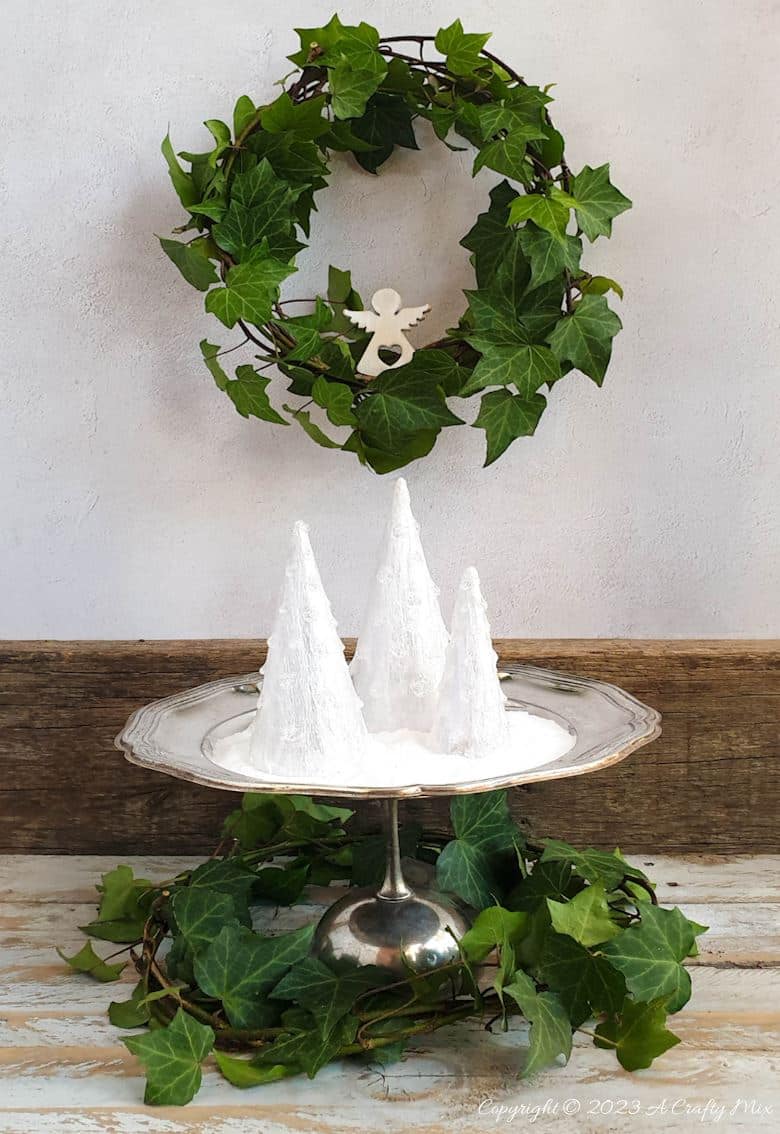 These upcycled shimmering light-filled Christmas trees are inexpensive and easy-to-make. The perfect holiday decorations to dress up your windowsill, tabletop, or mantel. They make lovely gifts too. No-one will ever believe they were thrown together in less than 30 minutes using plastic waste. Get the full tutorial at A Crafty Mix
