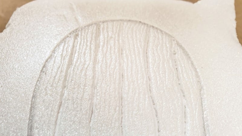 Use the sharp toothpick to draw squiggly lines that mimic woodgrain