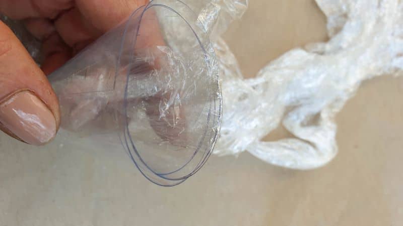 Tuck the ends of the cling film or plastic waste inside the cone