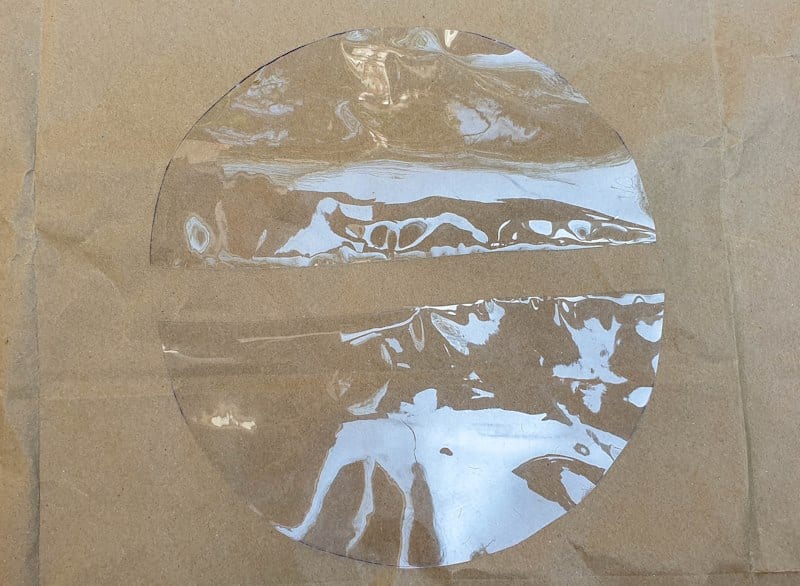 Cut the plastic circle in half