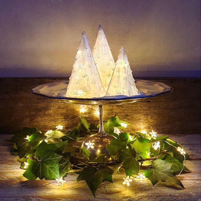 These upcycled shimmering light-filled Christmas trees are inexpensive and easy-to-make. The perfect holiday decorations to dress up your windowsill, tabletop, or mantel. They make lovely gifts too. No-one will ever believe they were thrown together in less than 30 minutes using plastic waste. Get the full tutorial at A Crafty Mix