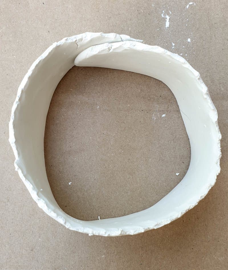Fold the flattened worm over itself to form a tube