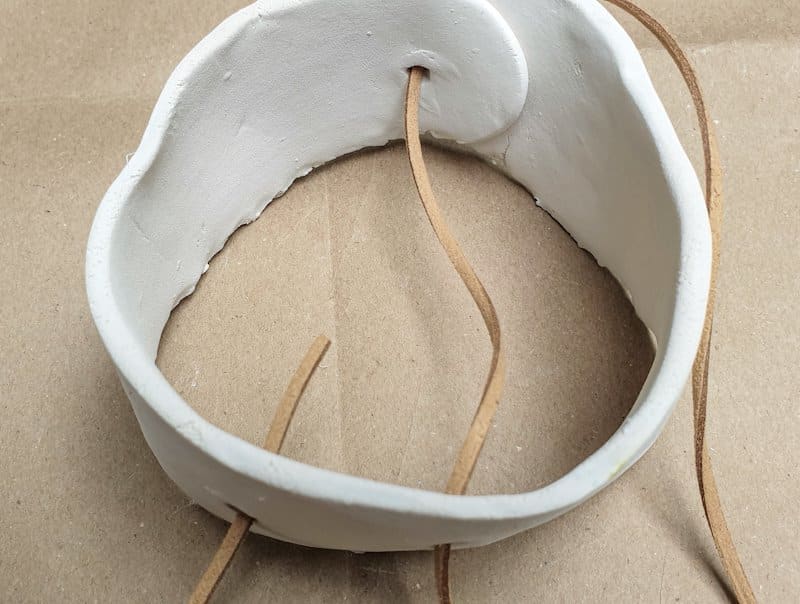 A view of the clay tubes while threading the cord through the holes
