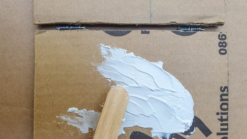 Smear the texture paste over the cardboard
