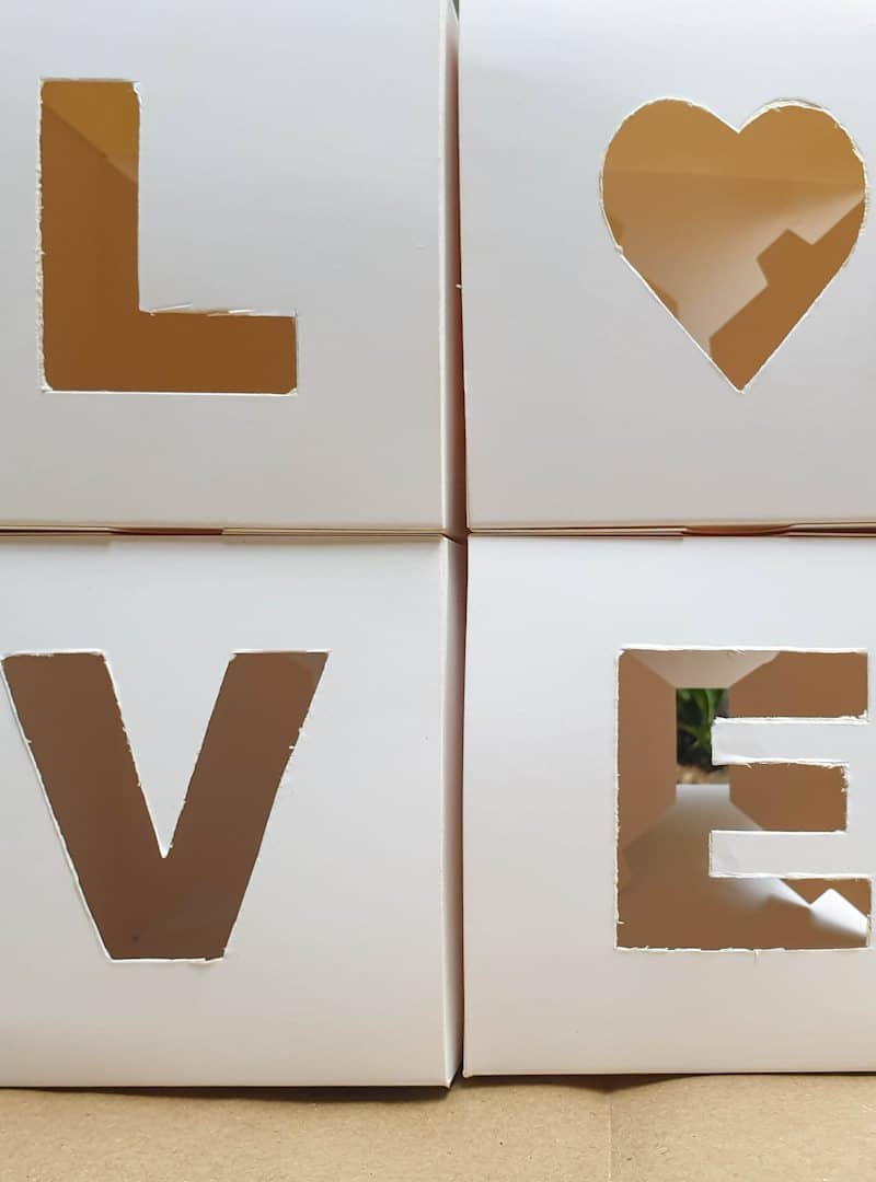 Small decorative cardboard boxes after the letters have been cut-out.