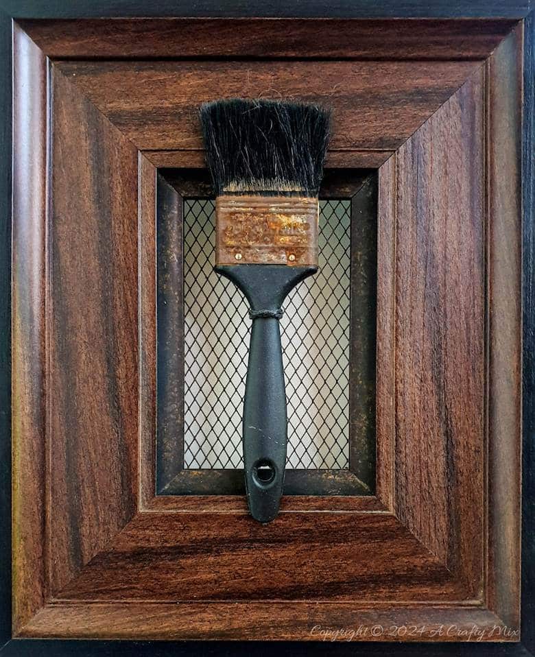 An old rusty paintbrush serves as an inspiration image to create the faux rust effect.