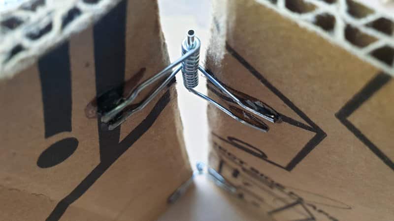 A view of the clothespin hinges installed on the cardboard heart frame