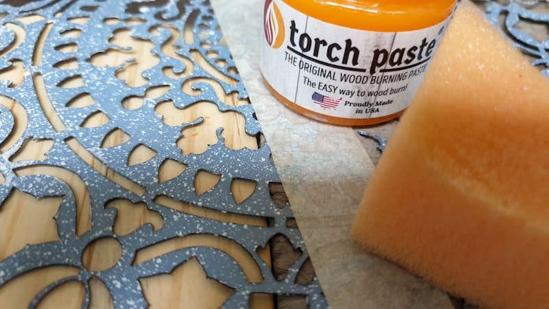 I used a sponge to apply the burning paste over a plastic stencil