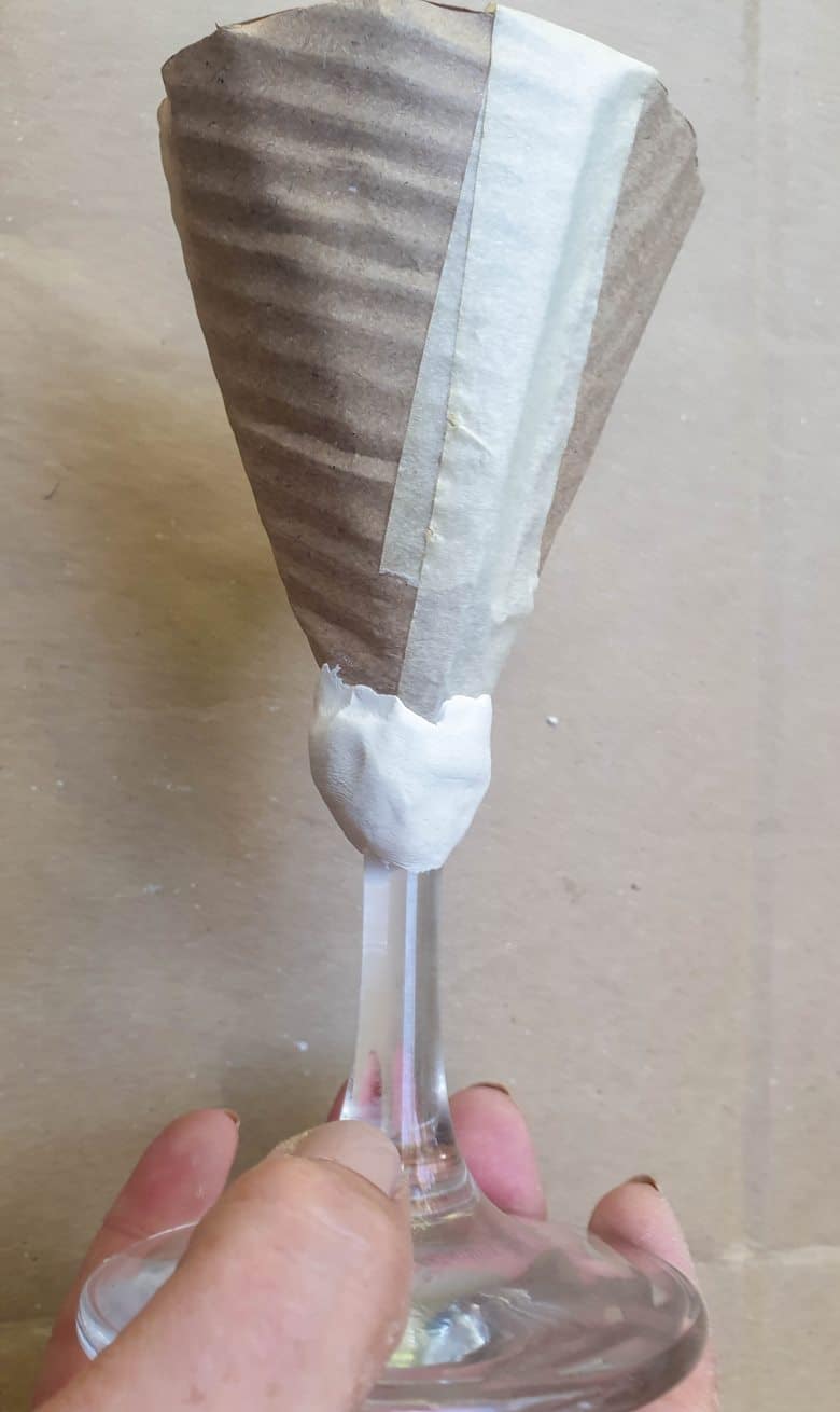 Place the cone on top of the clay blob and mold the vase form around the cone