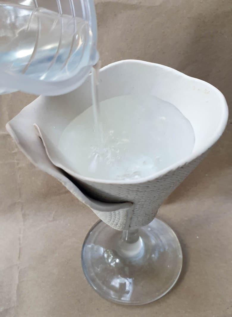 After baking leave the broken wine glass stem vase to cool down before adding water to test for leaks