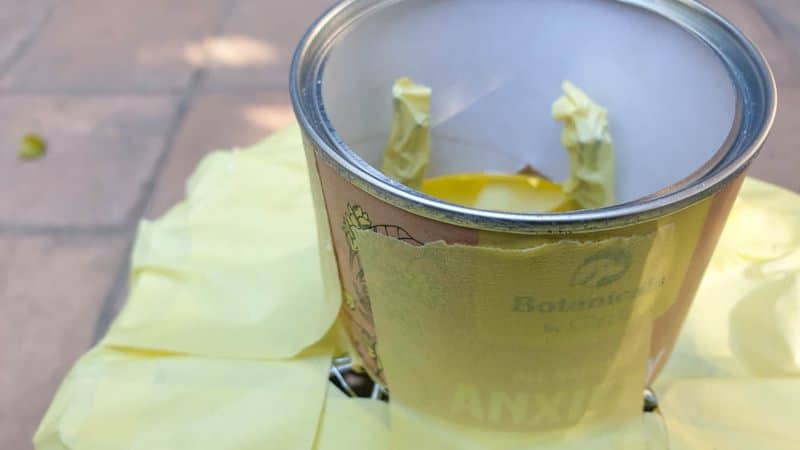 Tape the cardboard tube over the wire frame to form a neck for the woven oil basket