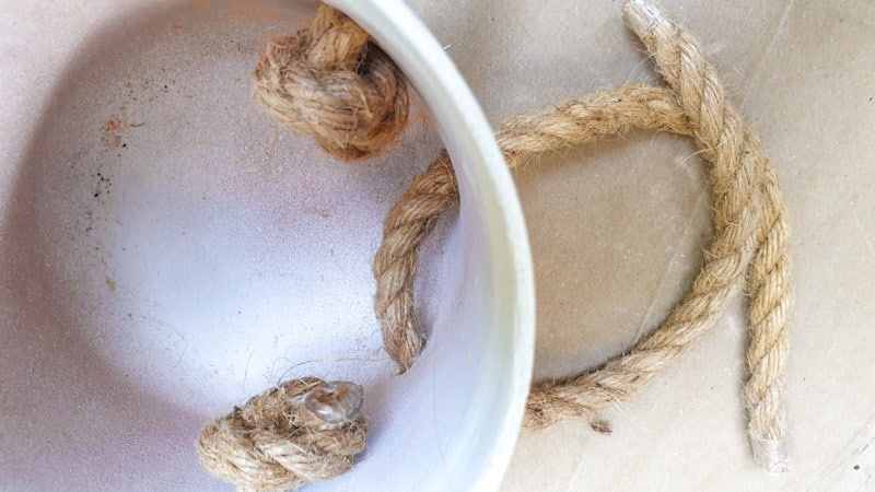 Tie a knot inside the planter to secure the arms
