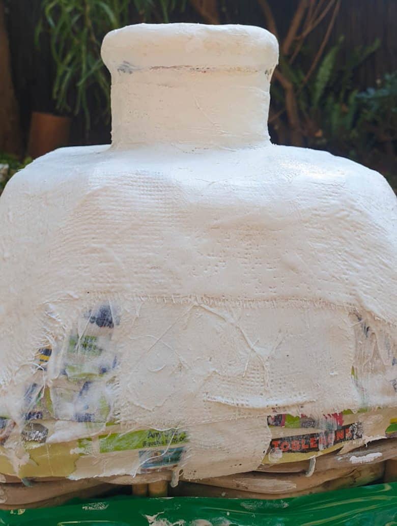 Apply plaster of Paris bandages over the paper Mache