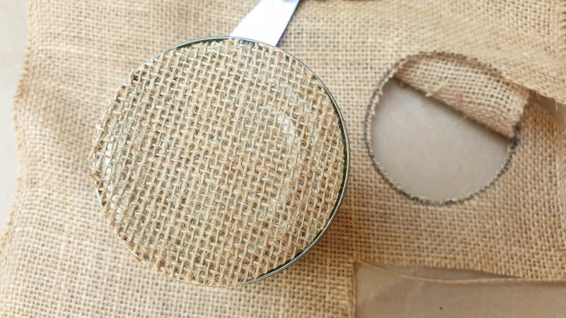Cut a circle of burlap or hessian for the bottom of the can